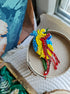 Anatomical heart beaded brooch hand embroidered with blue yellow and red beads, crystals, and sparkling chain details