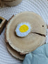 Fried egg beaded brooch hand embroidered with white glass beads, yellow yolk, and gold edge details
