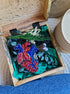 Decorative heart-shaped object with beadwork in a wooden box