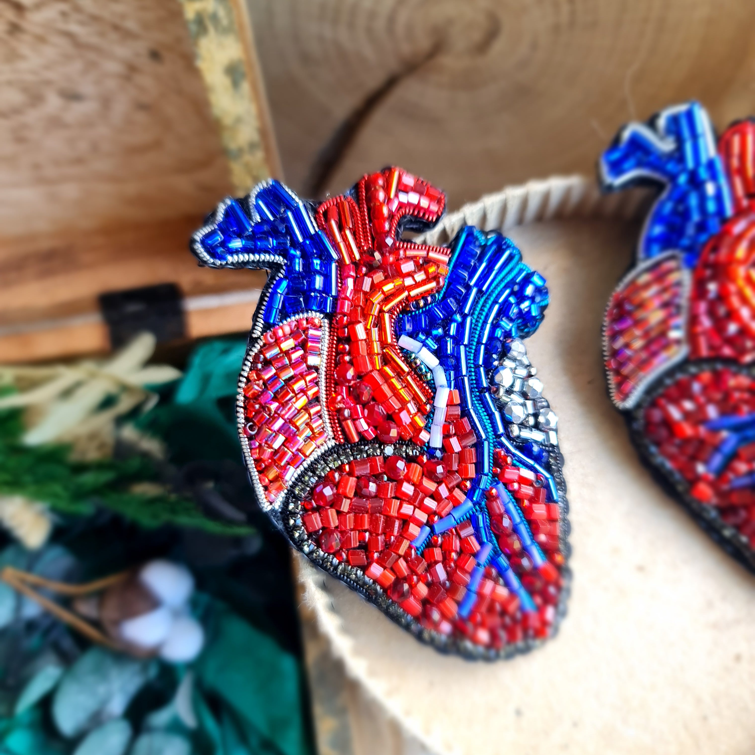 Anatomical heart beaded brooch hand embroidered with red and blue bead details