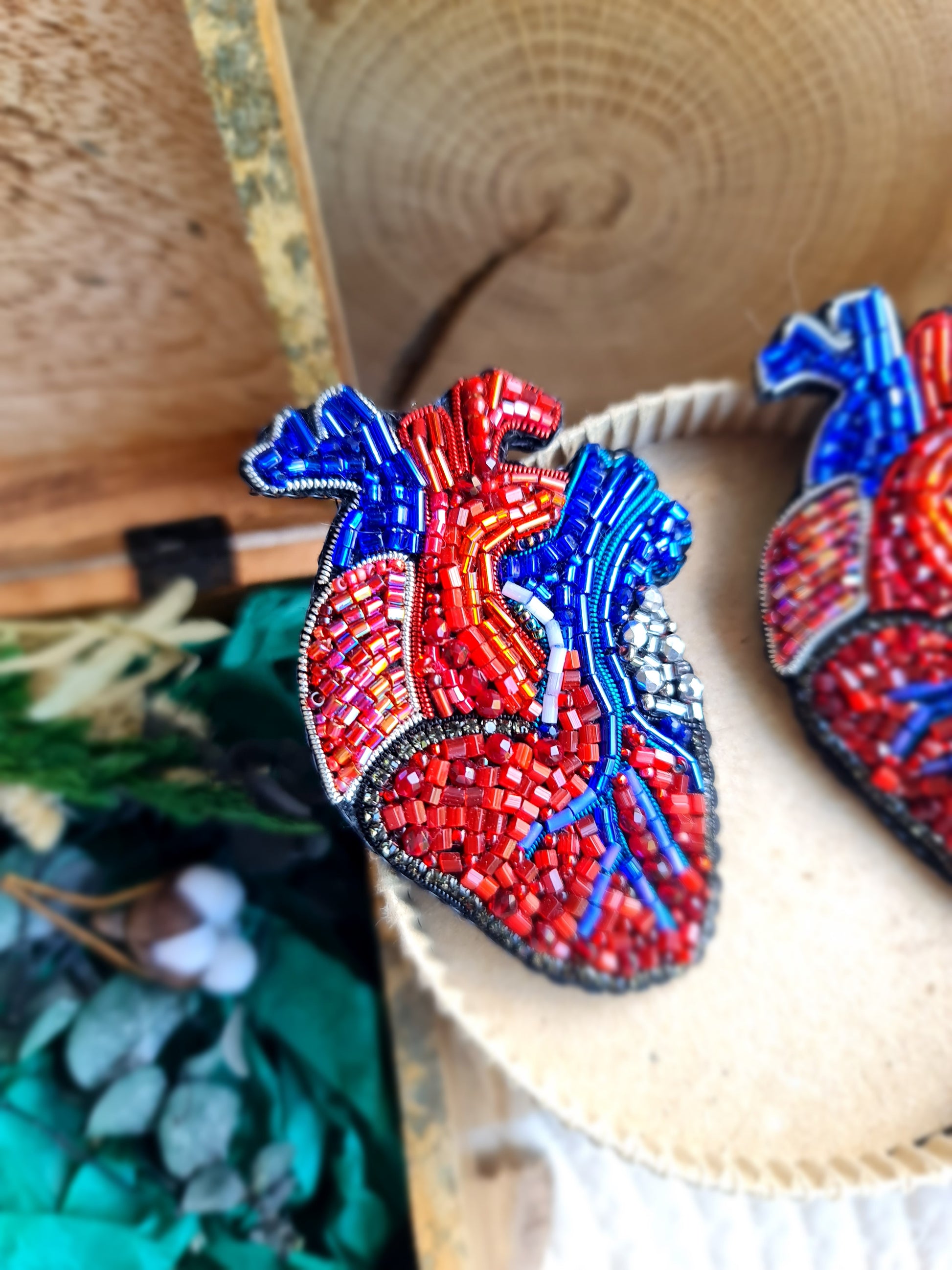 Anatomical heart beaded brooch hand embroidered with red and blue bead details