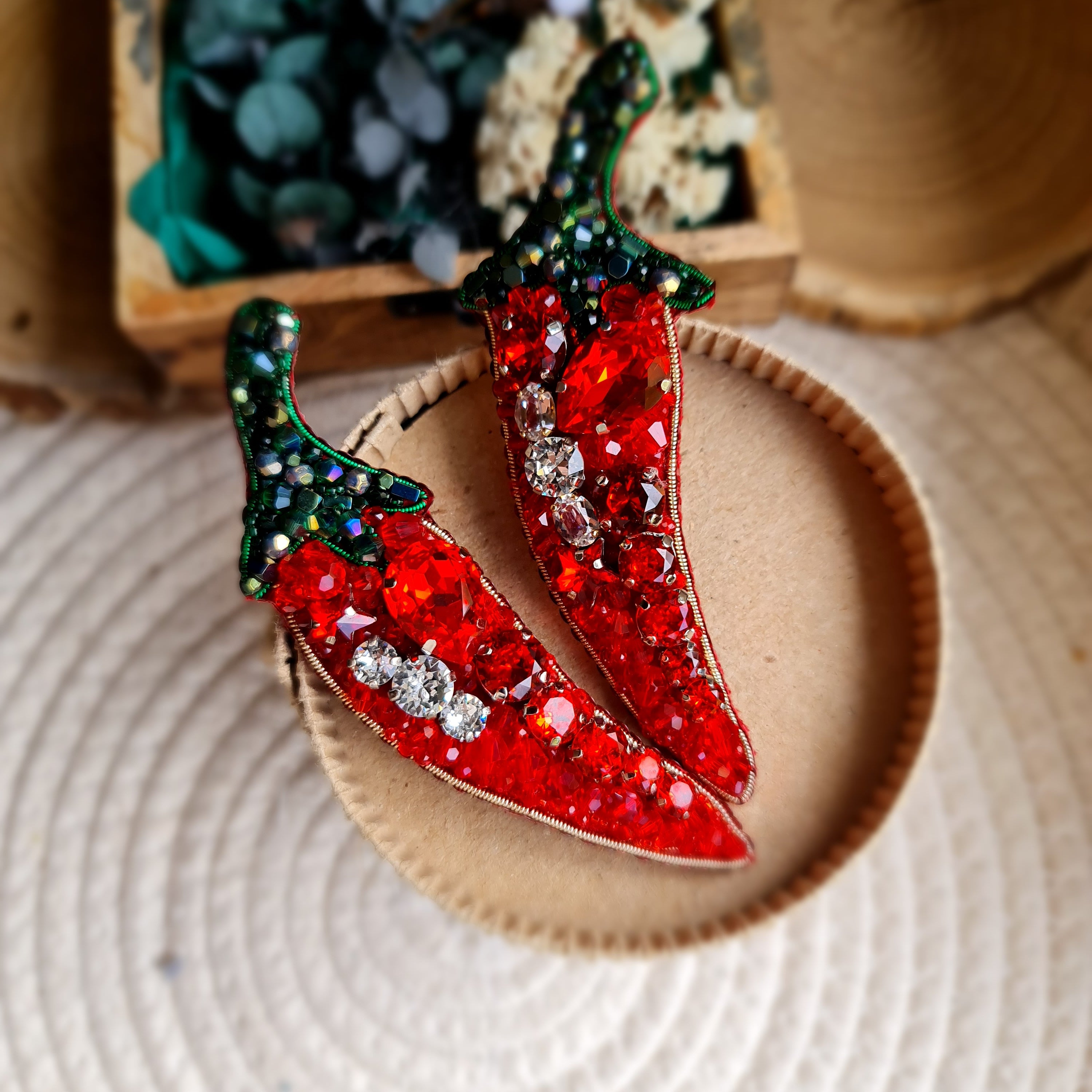 Chili pepper beaded brooch hand embroidered with red crystals green beads and sparkling details on straw bag