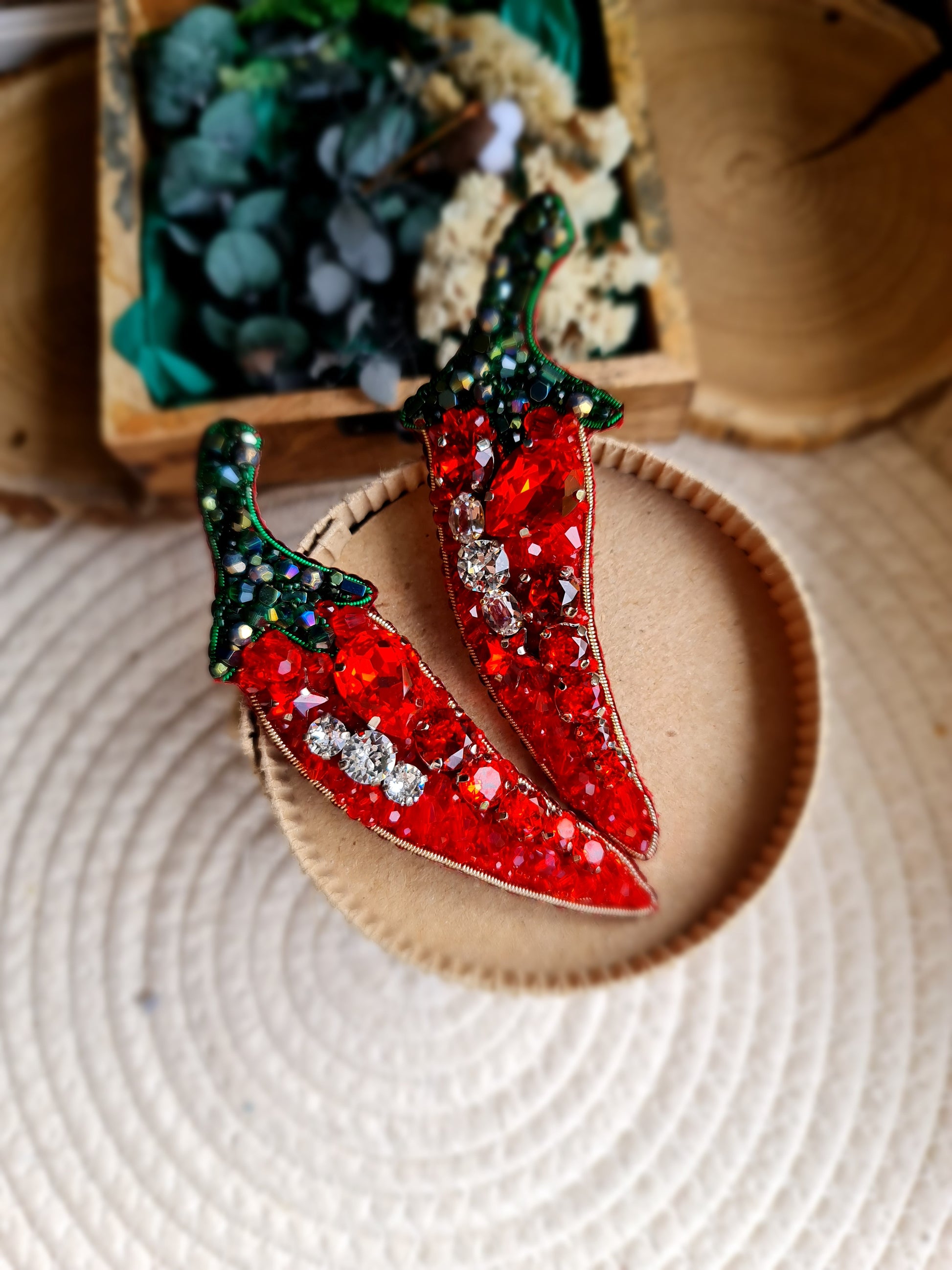 Chili pepper beaded brooch hand embroidered with red crystals green beads and sparkling details on straw bag
