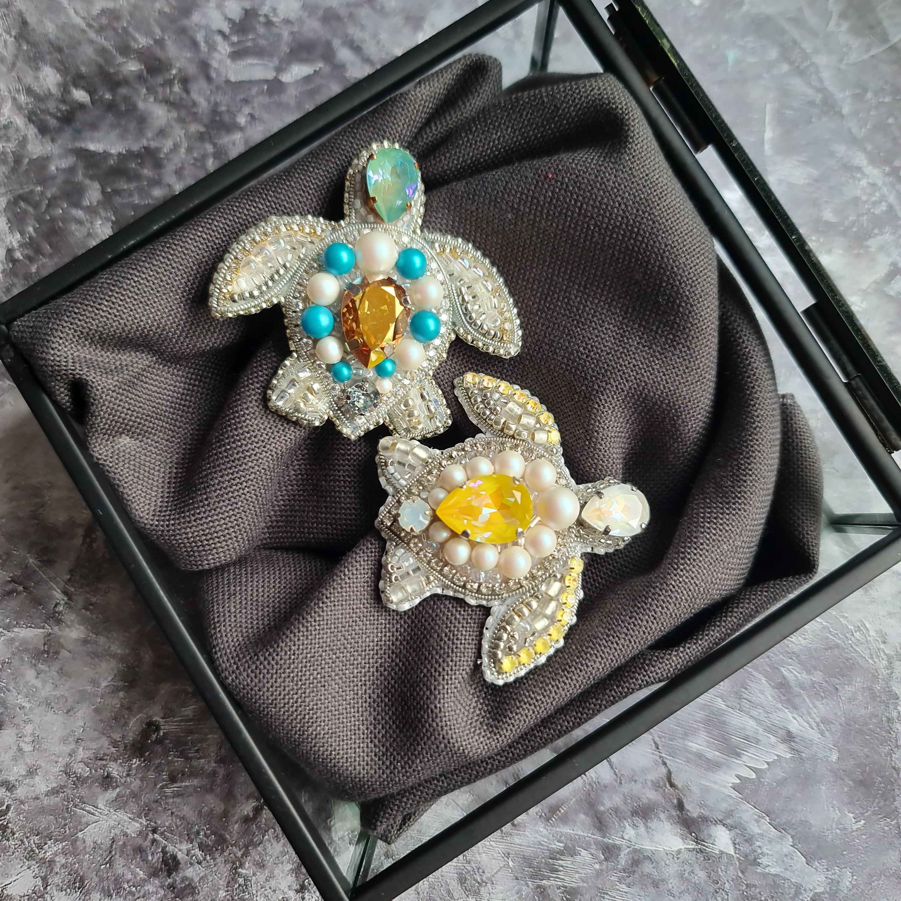 Sea turtle beaded brooch hand embroidered with white beads, pearls, yellow crystals, turquoise accents, and sparkling shell details