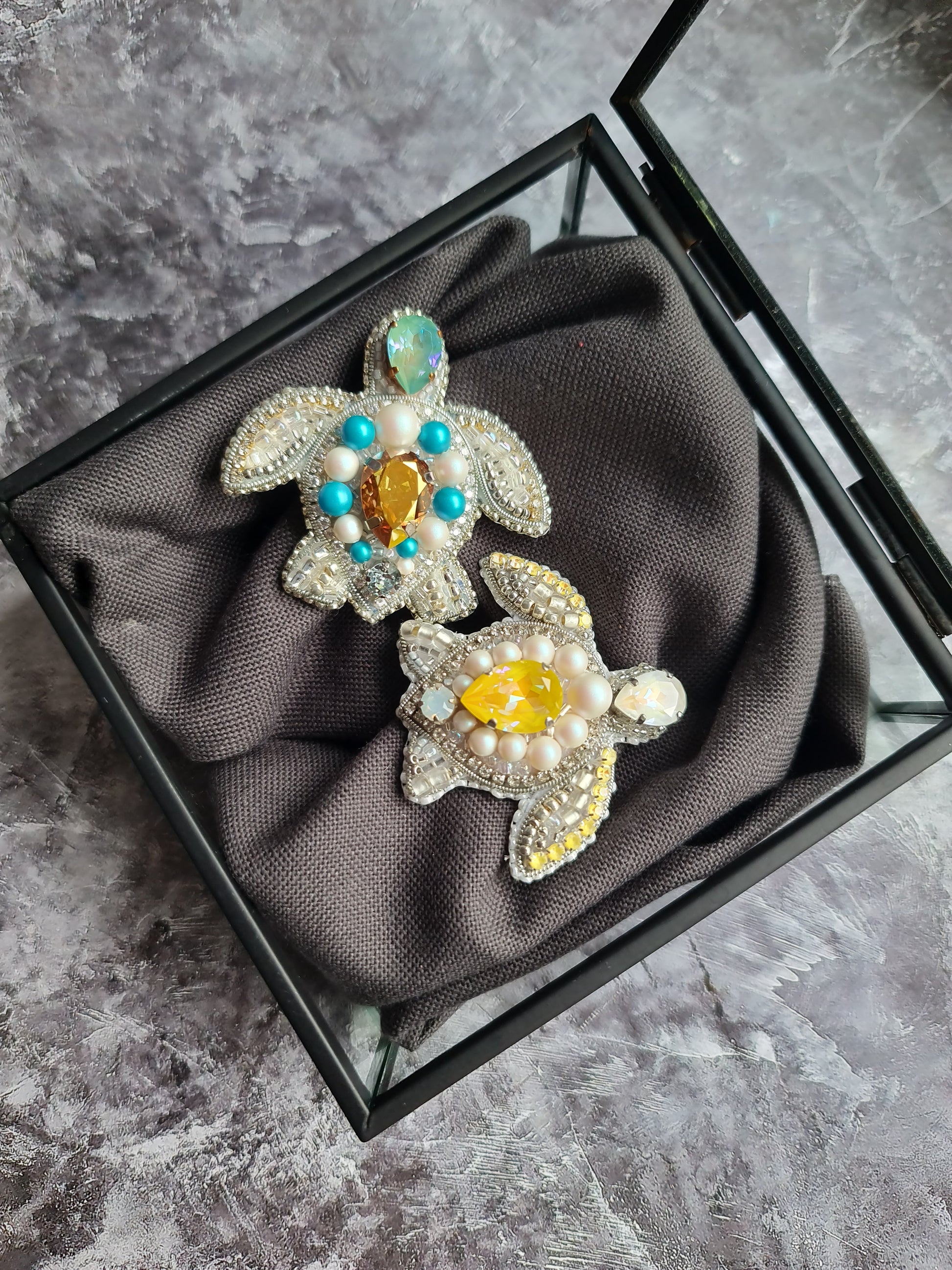 Sea turtle beaded brooch hand embroidered with white beads, pearls, yellow crystals, turquoise accents, and sparkling shell details