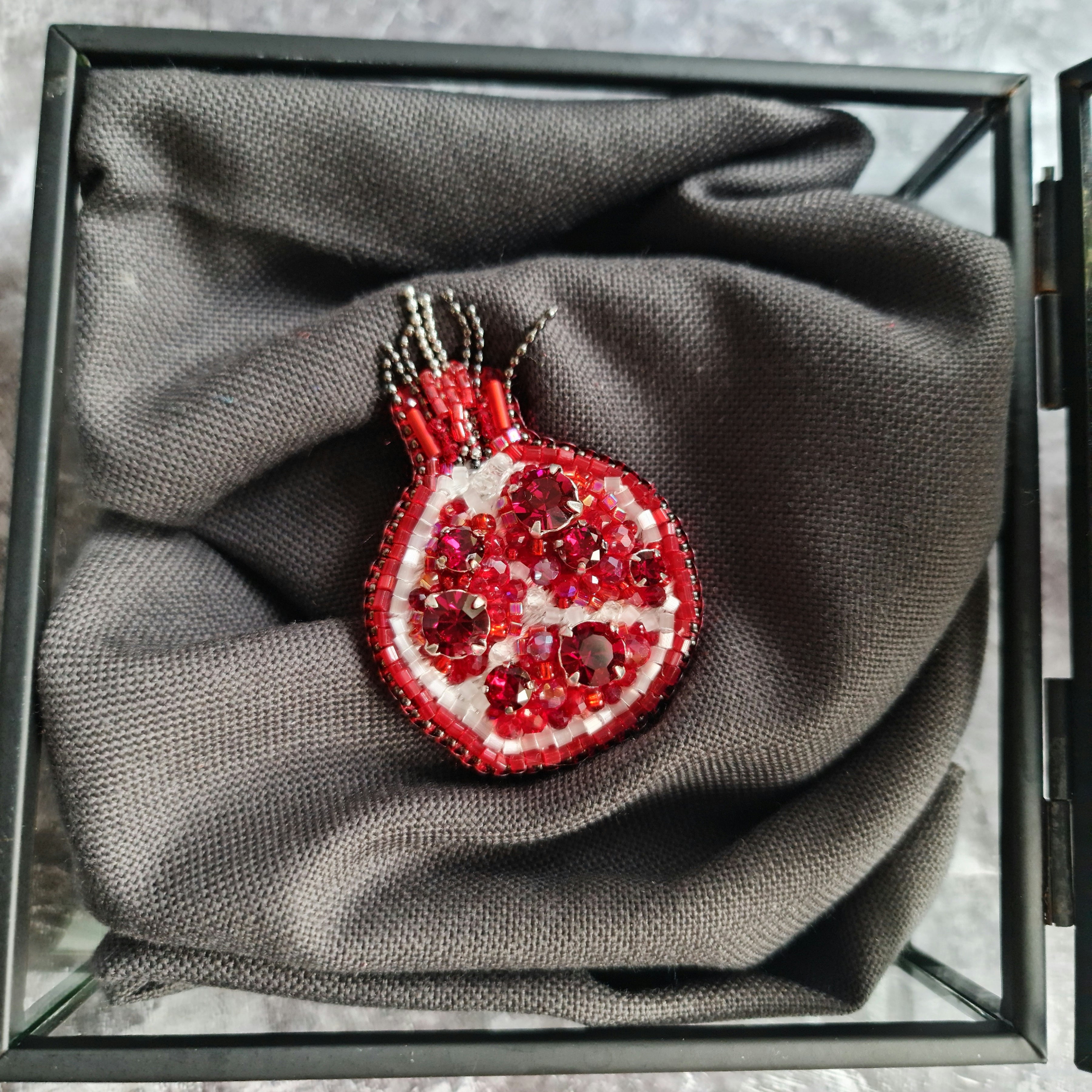 Red pomegranate beaded brooch hand embroidered with red crystals, white beads, pearls, and sparkling fruit details, available in small and large sizes