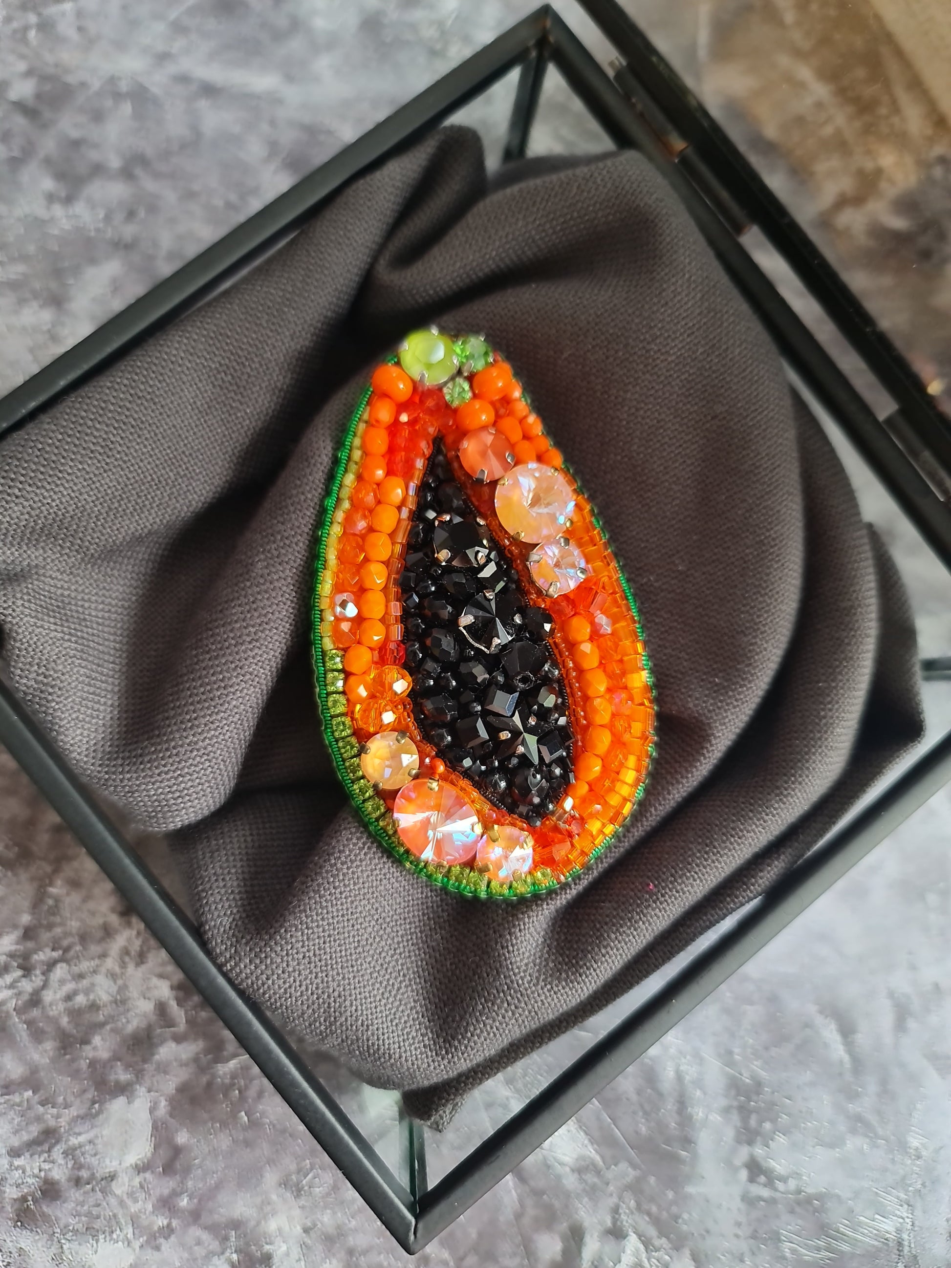 Papaya beaded brooch hand embroidered with orange beads black seed details green edge and sparkling crystals