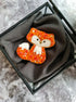Handmade fox beaded brooch in orange tones with fluffy white tail detail and embroidered face