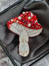 Handmade ruby mushroom brooch with crystals, pearls and detailed embroidery inspired by woodland nature