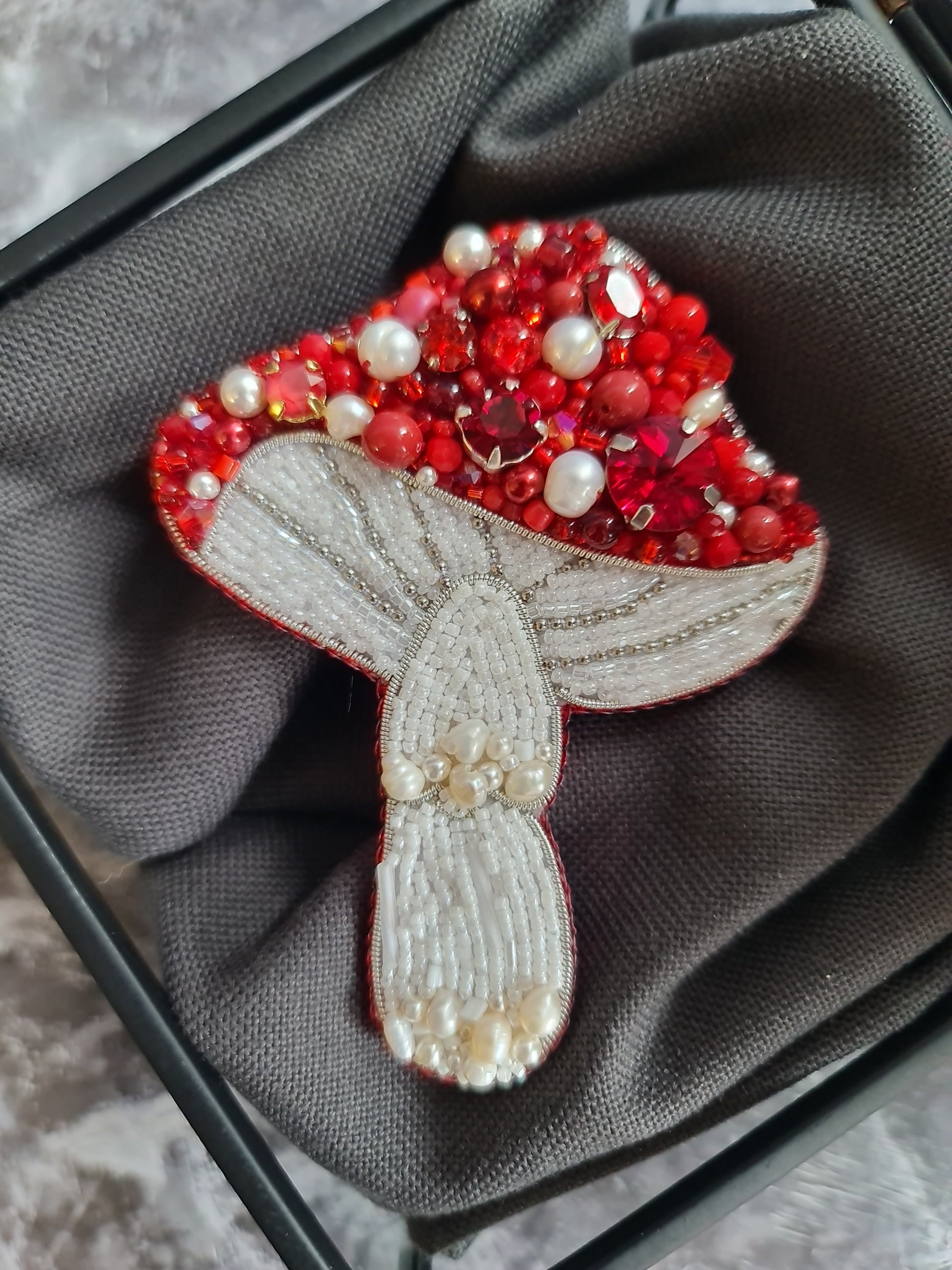 Handmade ruby mushroom brooch with crystals, pearls and detailed embroidery inspired by woodland nature