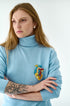 Model wearing the Anatomical Heart Embroidered Brooch pinned on a jacket, highlighting its artistic design and craftsmanship