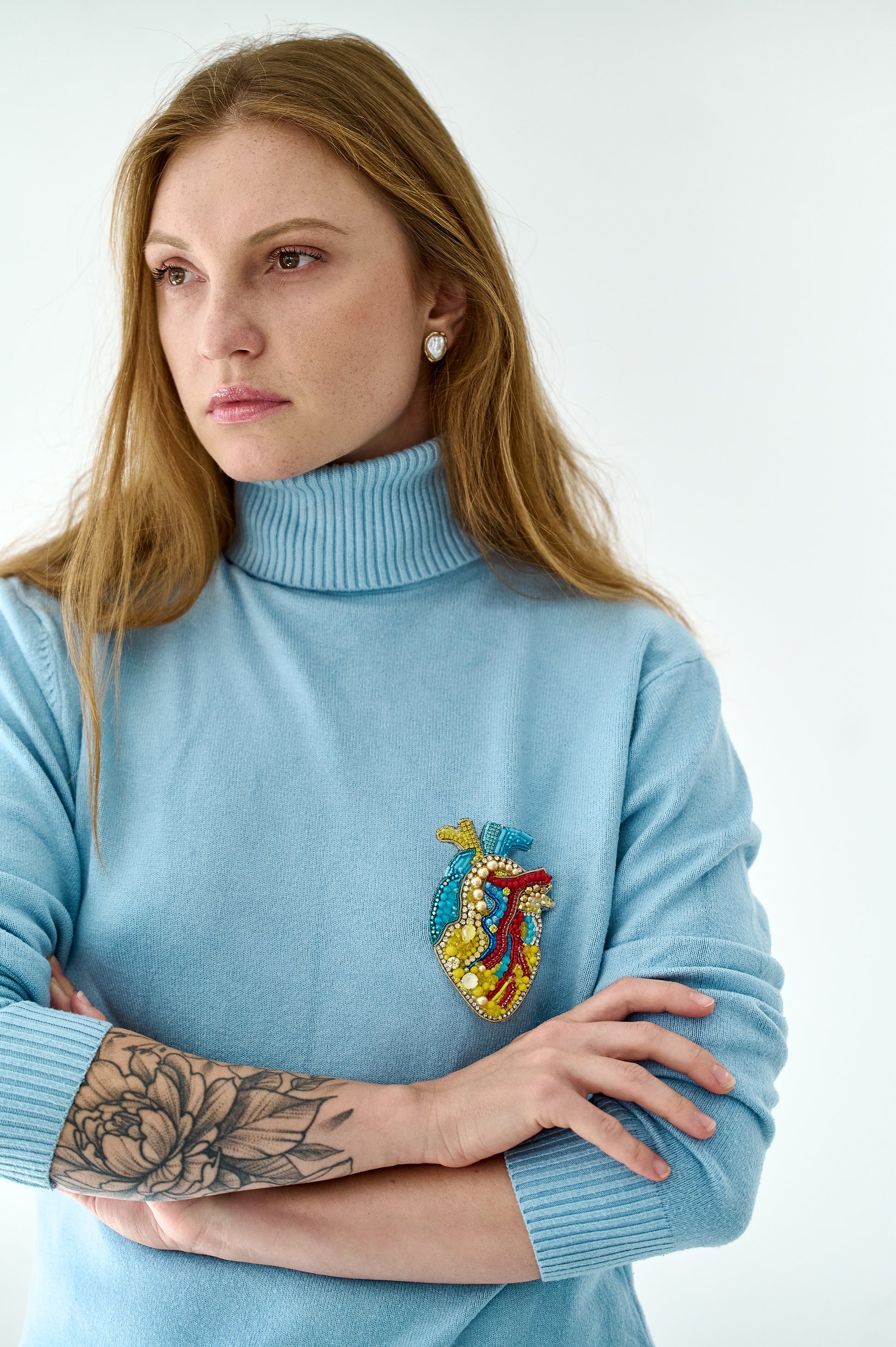 Model wearing the Anatomical Heart Embroidered Brooch pinned on a jacket, highlighting its artistic design and craftsmanship