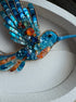 Decorative beaded hummingbird sculpture on a white background