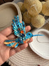 Blue hummingbird beaded brooch hand embroidered with turquoise sequins, orange accents, crystals, beads, and sparkling wing details