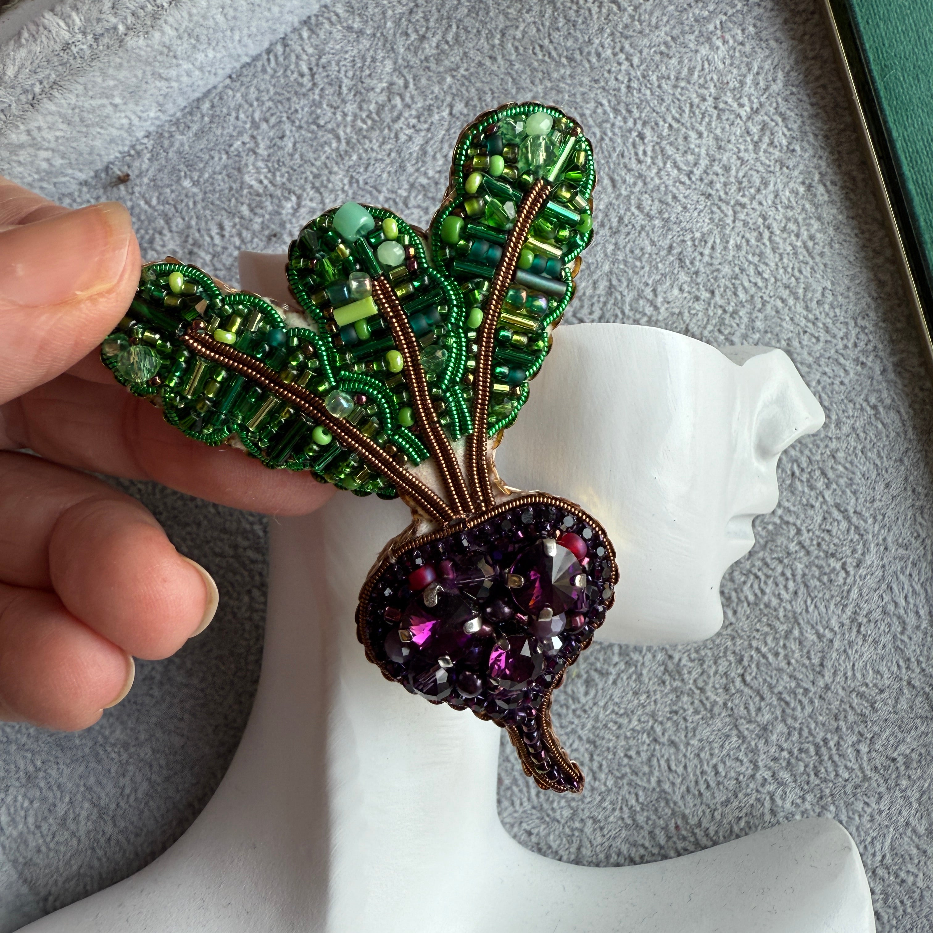 Handmade purple beet earrings with green leafy tops and sparkling violet crystals, embroidered with beads and inspired by fresh garden vegetables.