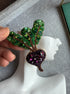 Handmade purple beet earrings with green leafy tops and sparkling violet crystals, embroidered with beads and inspired by fresh garden vegetables.