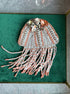 Decorative jellyfish sculpture with beads on a green background