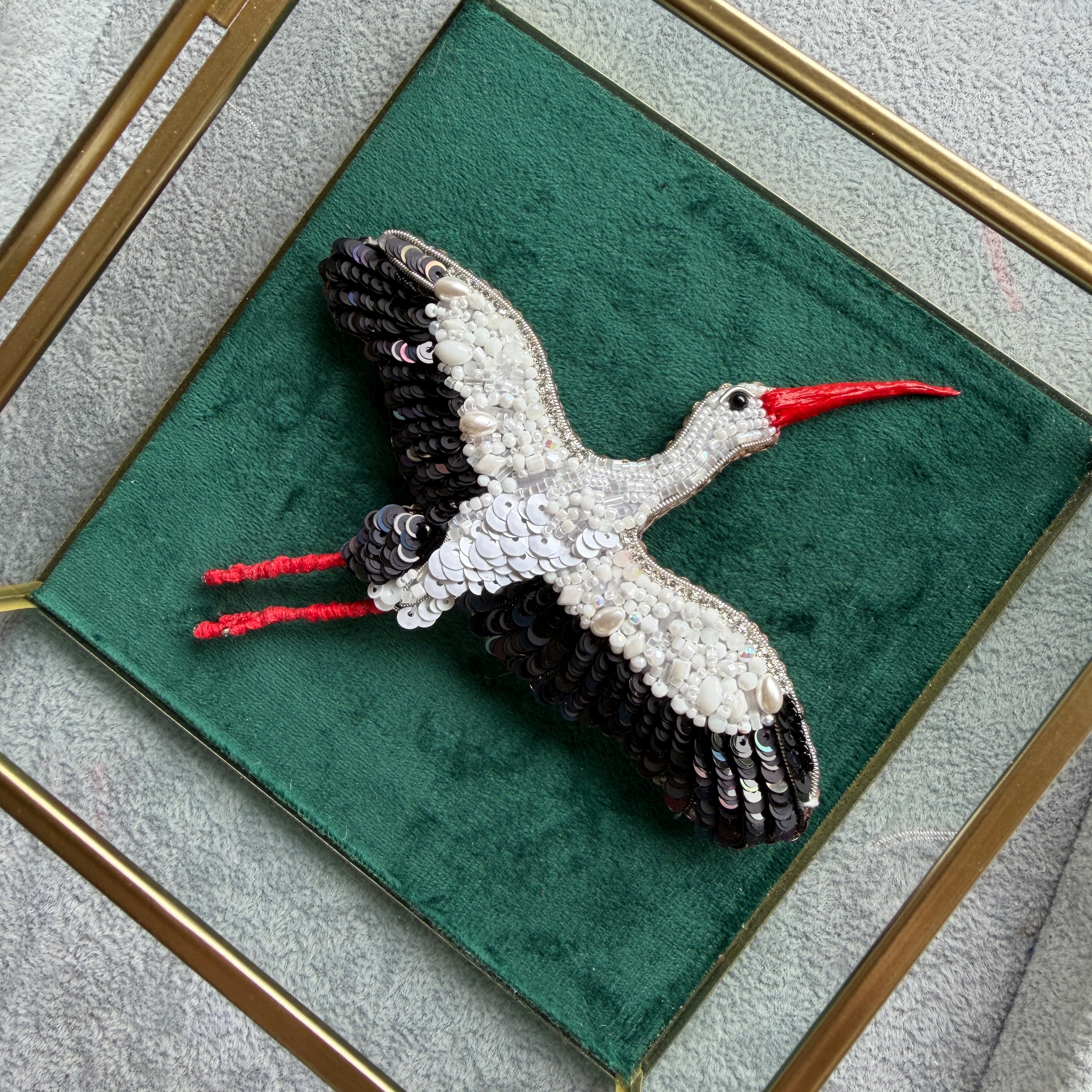 White stork beaded brooch hand embroidered with black wings and red beak