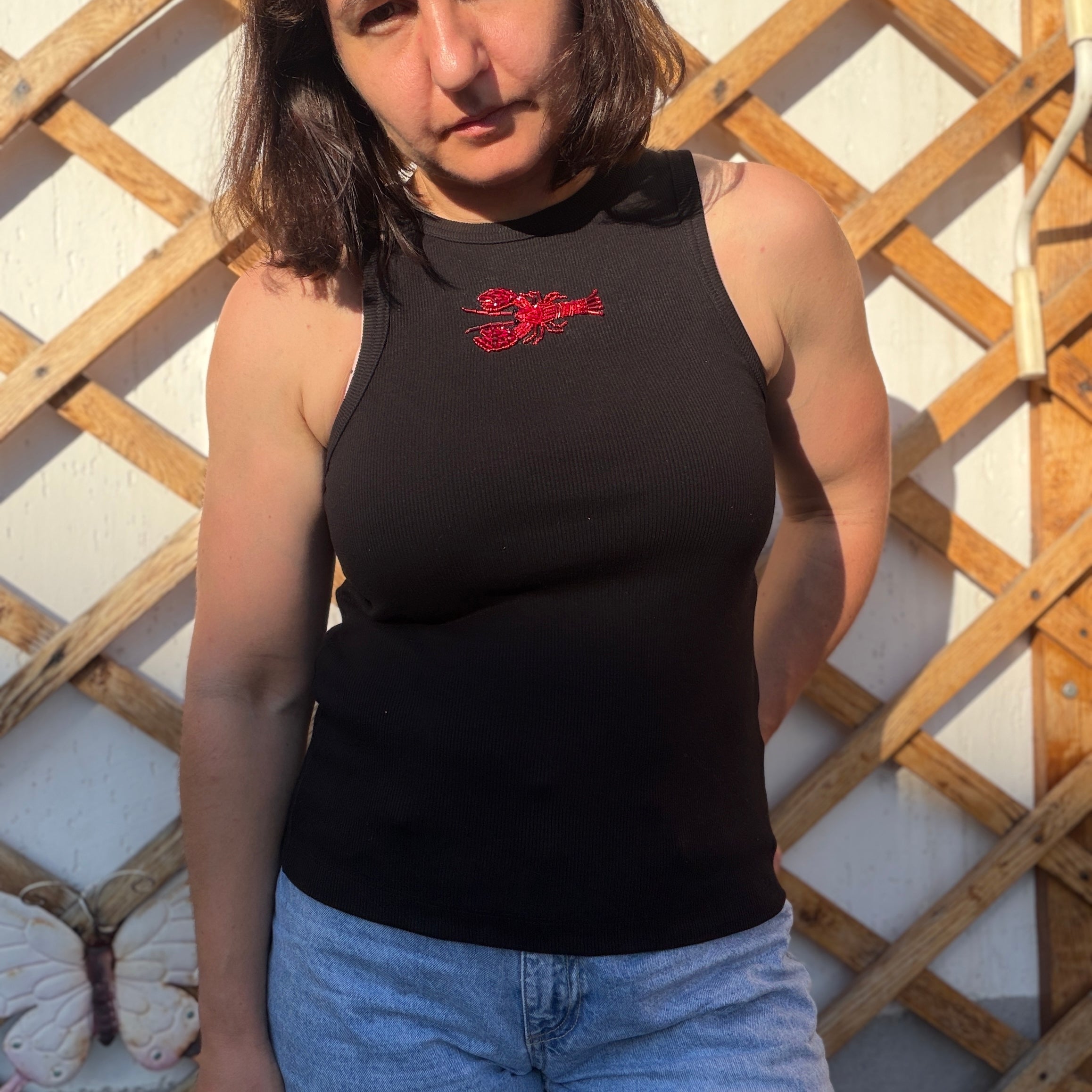 Black ribbed tank top with handmade red lobster embroidery, beaded seafood design, and wearable art detai