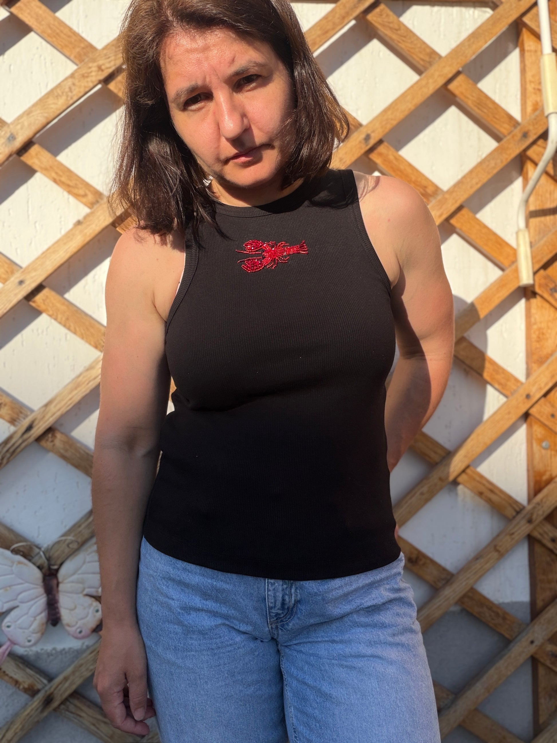 Black ribbed tank top with handmade red lobster embroidery, beaded seafood design, and wearable art detai