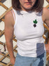 Person wearing a white tank top with a blackberry design against a wooden lattice background