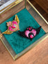 Detailed view of gold and pink Sailor Moon inspired beaded heart brooch featuring shimmering crystal accents and decorative beadwork.