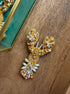 Close-up of a golden lobster accessory embroidered with glass beads, shimmering crystals, pearl accents, and intricate gold details.
