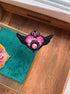 Handmade Sailor Moon inspired black winged heart brooch with pink crystal embroidery and red gemstone accent, displayed in hand.