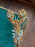 Handmade gold lobster beaded brooch with sparkling star crystals and pearl details, held in hand above a green velvet jewelry box.