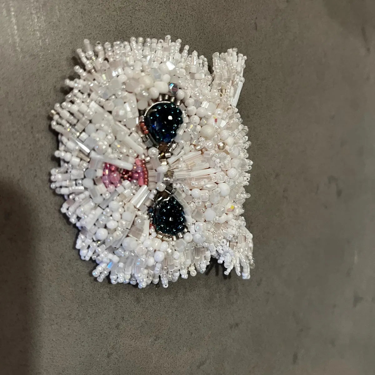 Beaded phone case with a design on a gray background