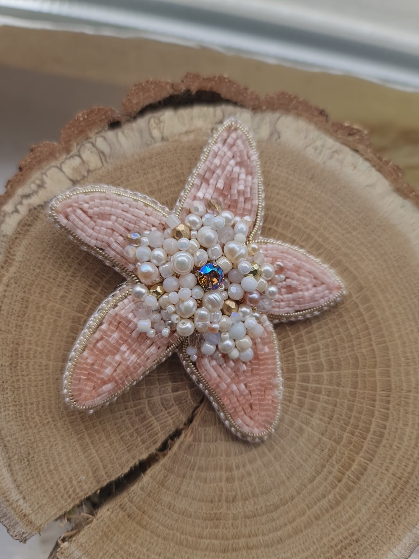 Close-up of the Stellar Seas Starfish Brooch showcasing detailed beadwork and embroidery with delicate Japanese beads, crystals, and pearls on a starfish design.